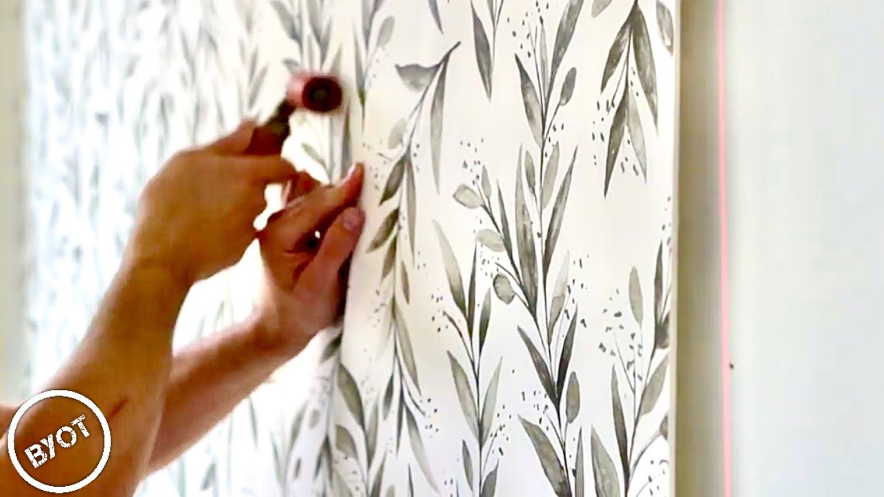 Wallpaper installation detail with installer at work